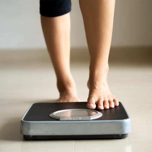Barefoot stepping on digital bathroom scale