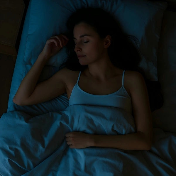 Woman sleeping peacefully in bed at night