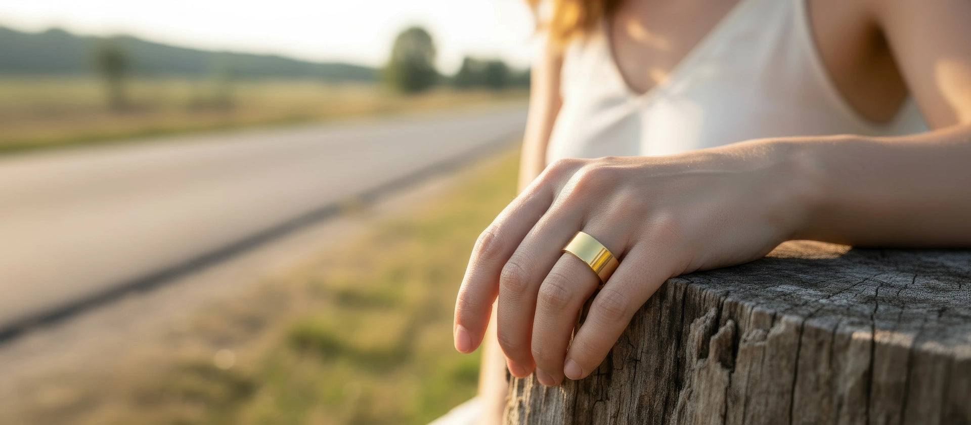 Elegant woman hand wearing a gold Omlezo ring on homepage banner