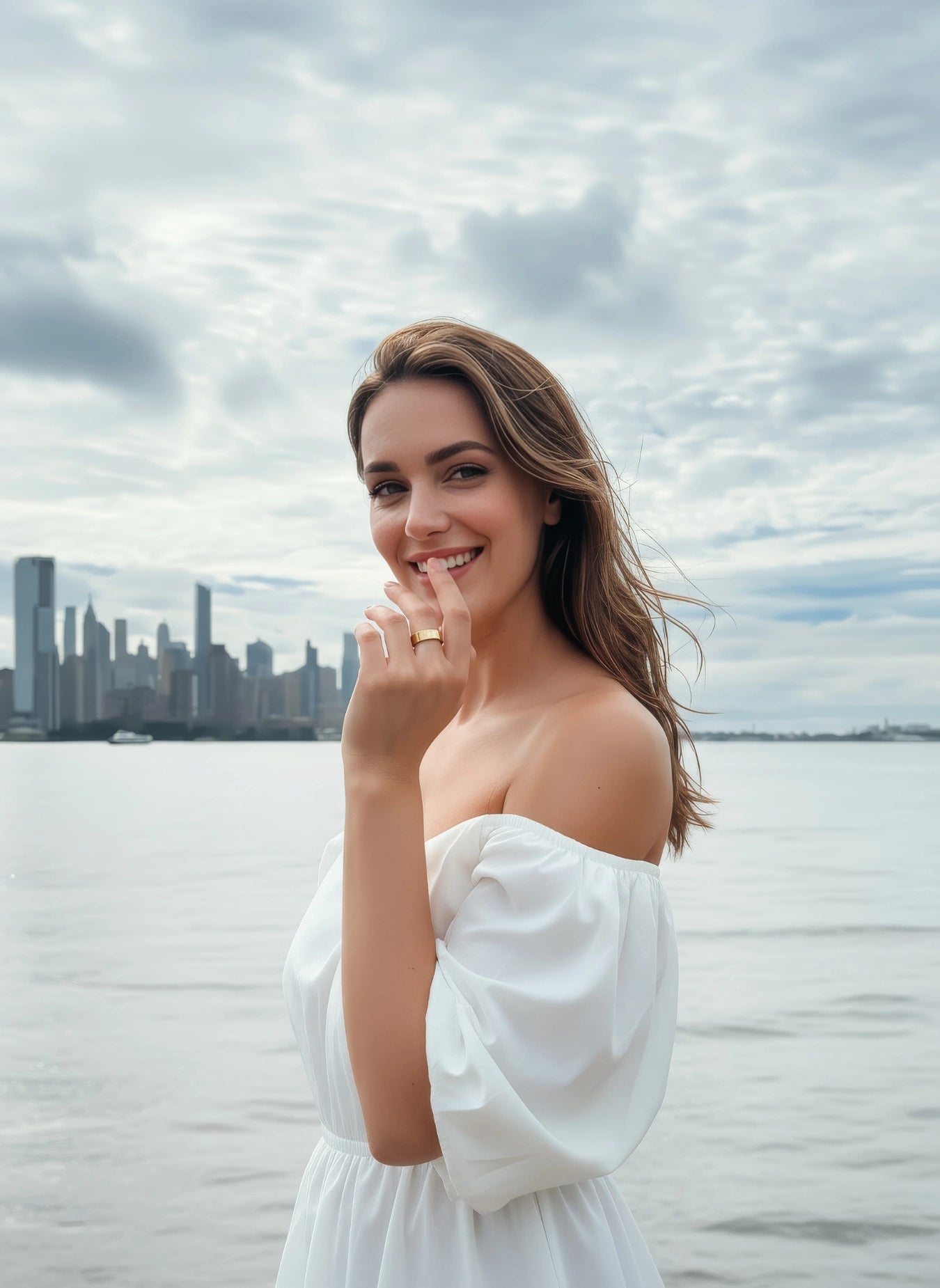 Smiling woman in white outfit wearing a gold Omlezo ring on her hand