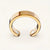 Close-up of the gold Omlezo Copper Magnetic Ring in a product display
