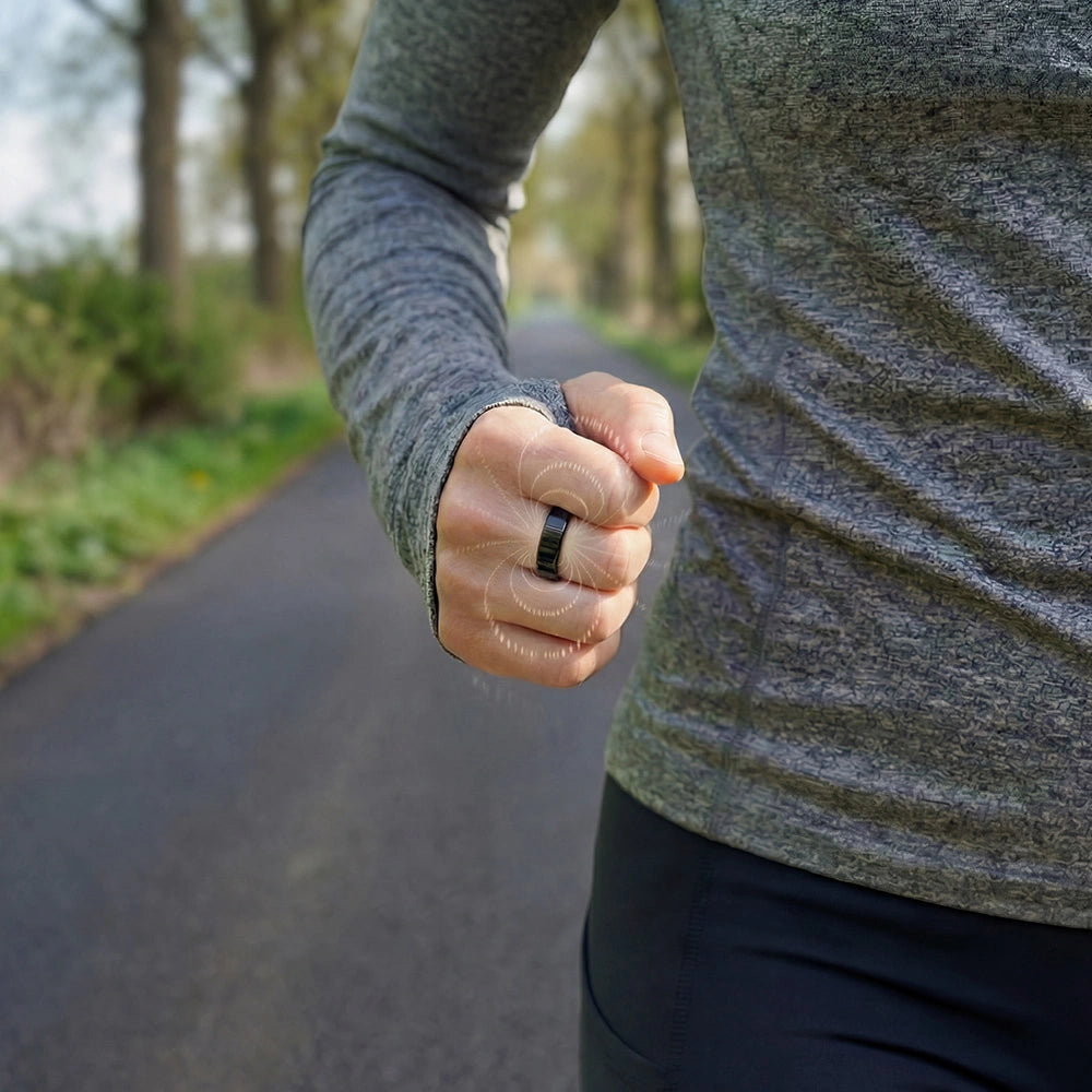A person running outdoors, wearing a gray long-sleeve top and a omelzo black magnetic copper ring, with their fist clenched.