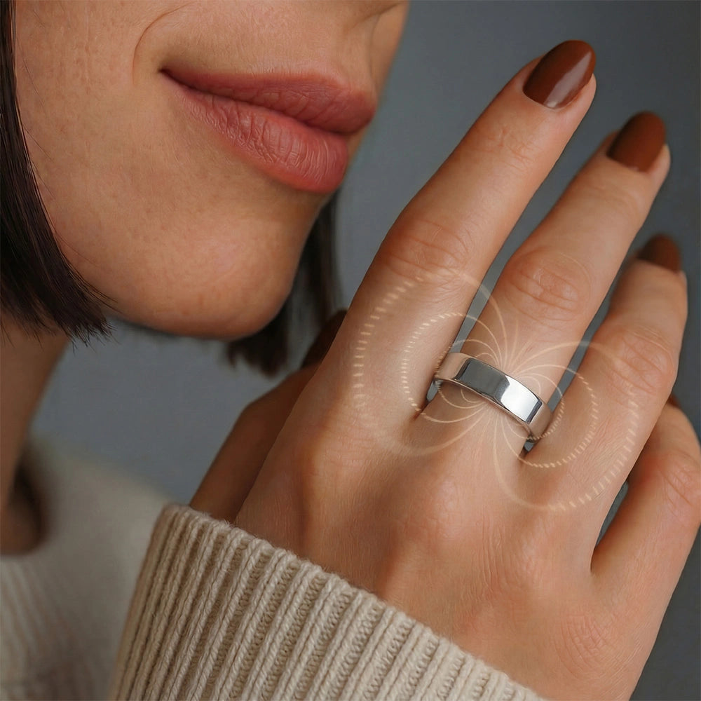 A close-up of a woman wearing a omlezo silver magnetic copper ring, with brown nails and a smile, showcasing the elegance of the jewelry.